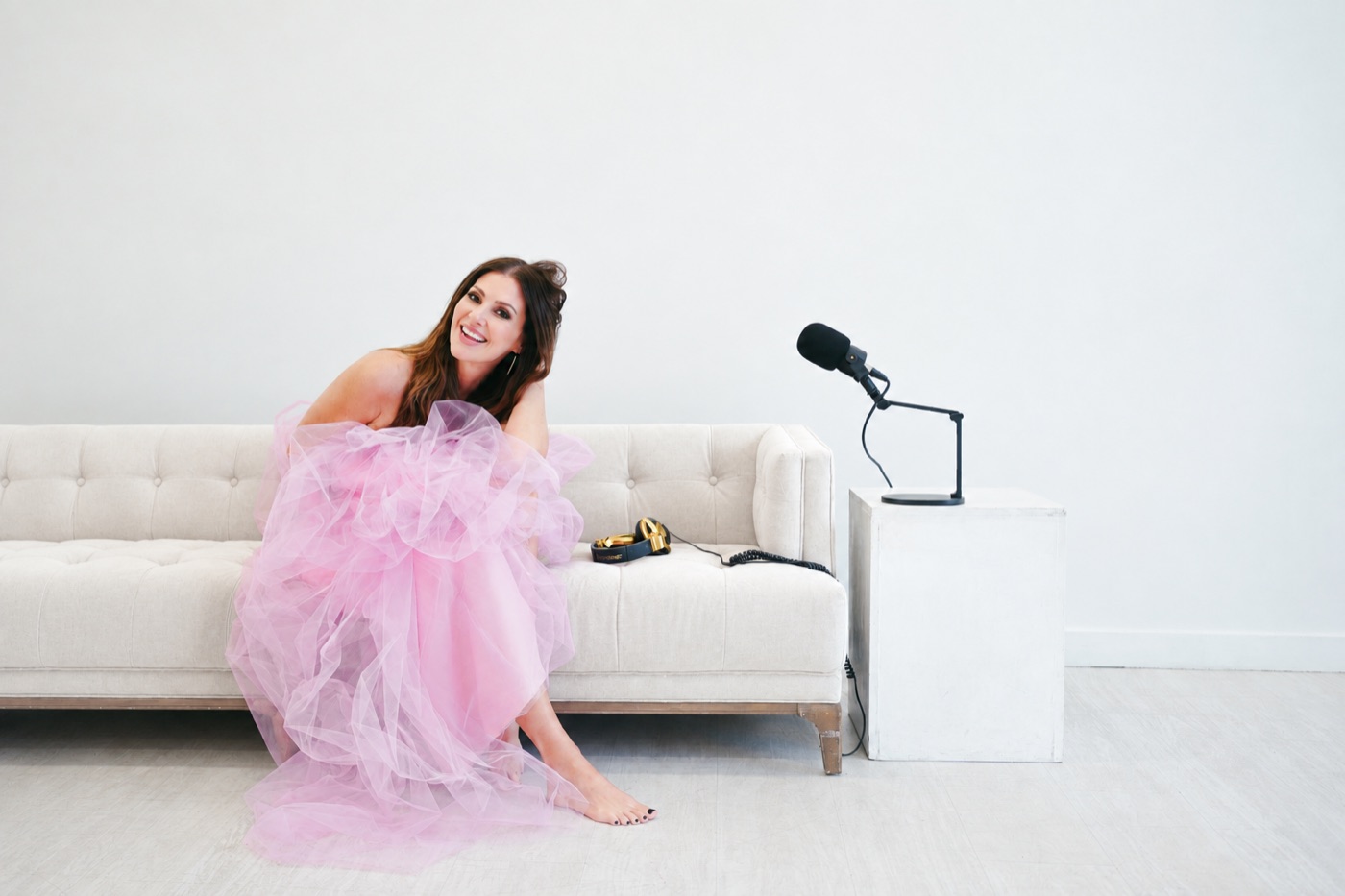 amy edwards in a pink gown on a sofa